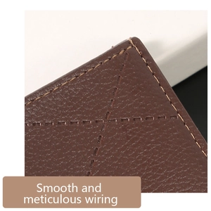 Macro shot of fine stitching on dark brown litchi texture leather wallet details