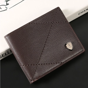 Macro detail of dark brown litchi grain leather wallet with X-shaped decorative stitching