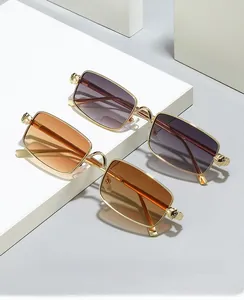Detail of vintage square metal sunglasses with embossed animal head temple decor