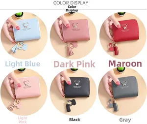 Close-up of small zipper purses in six pastel colors featuring bear charms and tassels