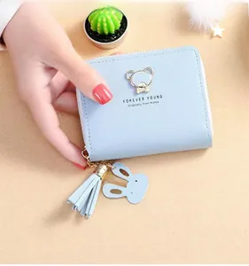 Detail of light blue PU leather wallet with golden bear clasp and decorative tassel