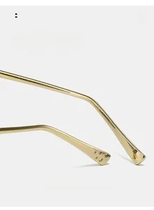 Detail of curved gold metal sunglasses arms with unique circular hollow tip design