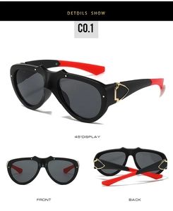 Detailed view of oversized butterfly sunglasses with gold shield accents and red tips