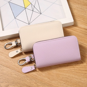 Minimalist PU leather key pouches with lychee pattern texture in cream and lilac colors