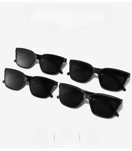 Flat lay of four oversized TR polarized sunglasses with classic black square frames