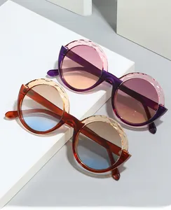 Detail view of round trendy sunglasses showing side frame texture and gradient lenses