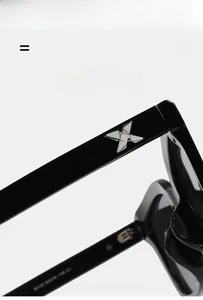 Close-up of black TR frame sunglasses temple with silver metal X-shaped ornament detail