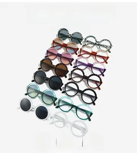 Close-up of assorted retro round frame sunglasses in black, ivory, and tortoiseshell