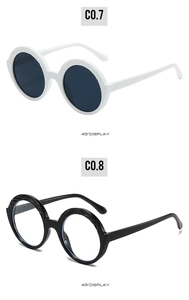 Detailed 45-degree side view of round oversized sunglasses with unique carved frame textures