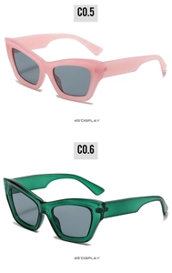 Detailed 45-degree view of cat eye sunglasses in pink and dark green frames