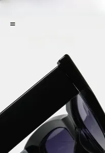 Detail shot of black high-gloss sunglasses temples with reinforced hinges and light frame