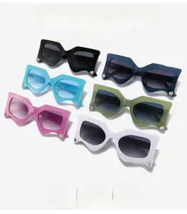 Detail of colorful trendy sunglasses with thick frames and heart-shaped rhinestones