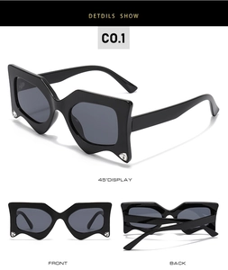 Detail of geometric black frame sunglasses with rhinestone accents and dark grey lenses