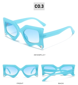 Detail view of light blue irregular geometric sunglasses with crystal rhinestones