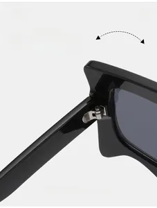 Detail of durable metal texture hinge on glossy black sunglasses showing craft