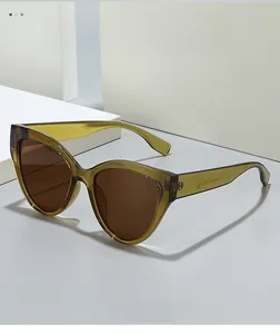 Detail shot of vintage cat-eye sunglasses in translucent olive green with brown lenses