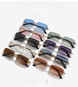 Close-up of rimless rectangle sunglasses in multiple colors with gold metal temples