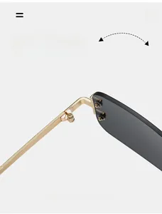 Macro shot of durable golden metal hinges and dark lenses on rimless sunglasses