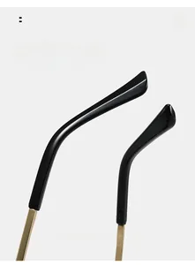 Detail view of curved black and gold temple tips for comfortable rimless sunglasses