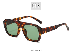 Detail view at 45-degree angle showing tortoise shell frame with dark green lenses