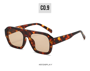 Detail view of square tortoiseshell sunglasses with brown lenses and metal hinges