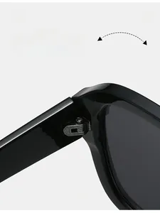 Macro shot of durable metal hinge on stylish oversized black square sunglasses