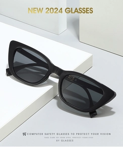 Close-up of black cat-eye folding sunglasses on white display stand with metal hinges