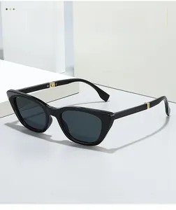 Detail of cat eye sunglasses with black frame and golden metal hinge on white steps