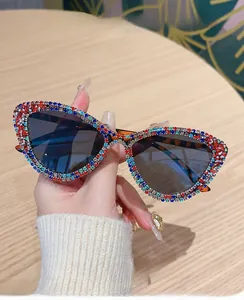 Detailed close-up of multi-colored rhinestones on cat-eye sunglasses frame