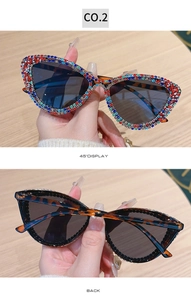 Detail of cat eye sunglasses with multi-color rhinestones and leopard print arms