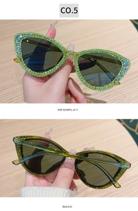 Detail view of green cat eye sunglasses with rhinestones and 45-degree angle back display