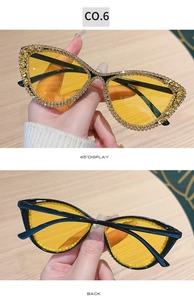 Detail of cat eye sunglasses featuring sparkling gold rhinestones and yellow lenses