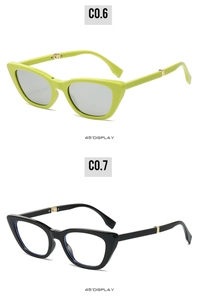 Detail view of foldable cat-eye sunglasses with metal hinges in green and black frames
