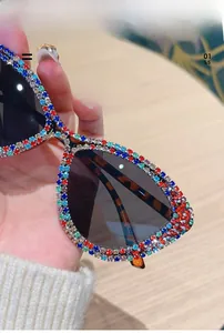 Detailed close-up showing multicolored rhinestones on cat-eye sunglasses frame with tortoise temple