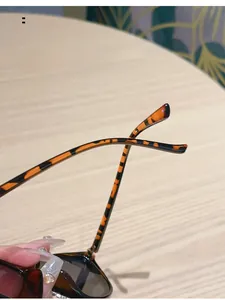 Close-up of tortoise shell cat-eye sunglasses featuring ergonomic curved temples for comfort