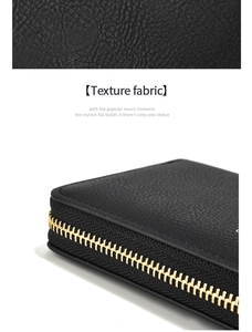 Détail de la texture cuir litchi noir avec fermeture éclair en métal doré de qualité