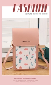 Detail of pink floral touchscreen phone bag on wood desk with minimalist shoulder strap