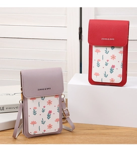 Detail of crossbody phone bags in red and lilac with floral prints and brand logo