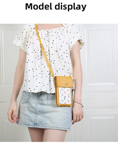 Yellow floral crossbody phone bag worn by a model against a white classic door