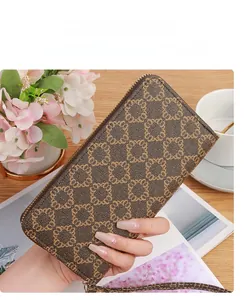 Lifestyle shot of a long zip wallet with floral prints on a cozy wooden table