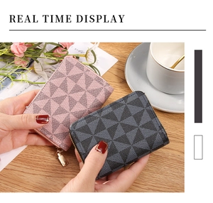 Close-up of pink and black leather card holders with geometric pattern and metal zipper