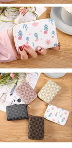 Detailed display of accordion card wallets in floral and geometric patterns with zippers