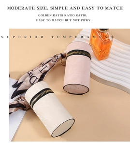 Mini cylindrical leather coin purse with golden zipper and silk scarf charm detail