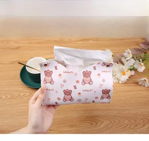 Detail view of leather tissue box with cute bear pattern and gold metal snap buttons