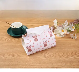 Detail of light beige faux leather tissue box cover with a cute bear and metal snaps