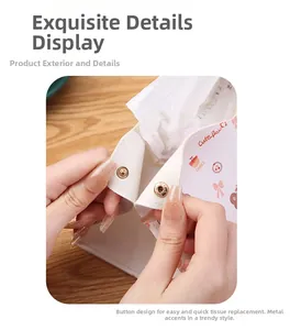 Detail view of the rose gold snap button on a white leather cartoon tissue box cover