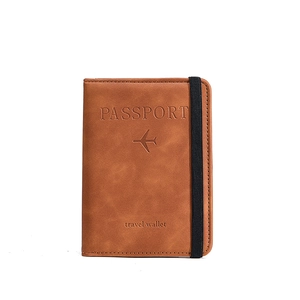 Brown PU leather travel passport wallet with elastic strap and engraved airplane design