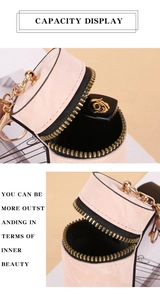 Pink cylindrical mini pouch with zipper and golden keychain for lipstick storage