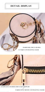 Detail of champagne pink mini coin purse with gold hardware and patterned silk scarf tie
