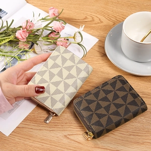 Slim geometric pattern zipper card wallets in brown and beige on a wooden table